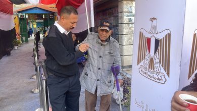 رجال الشرطة يساعدون كبار السن خلال الإدلاء بأصواتهم فى بولاق الدكرور